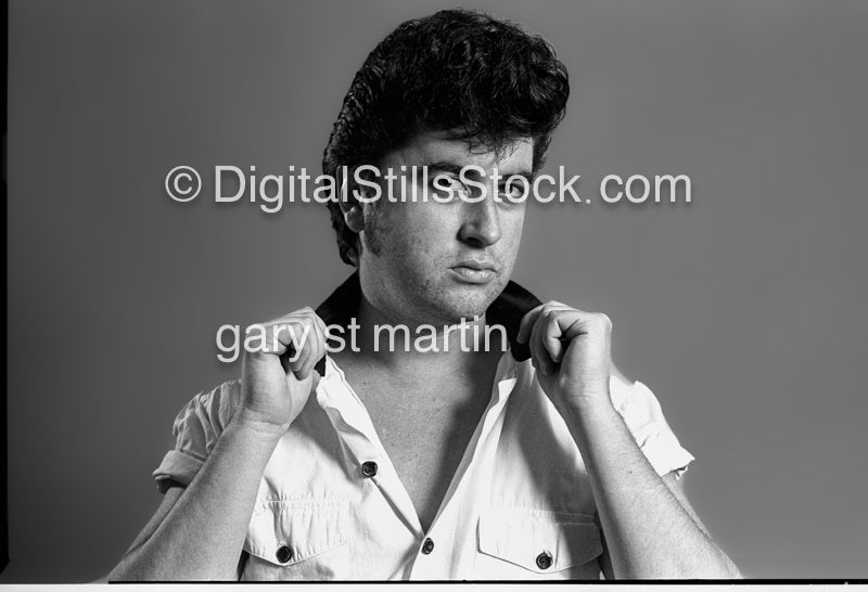 Hands on his shirt collar