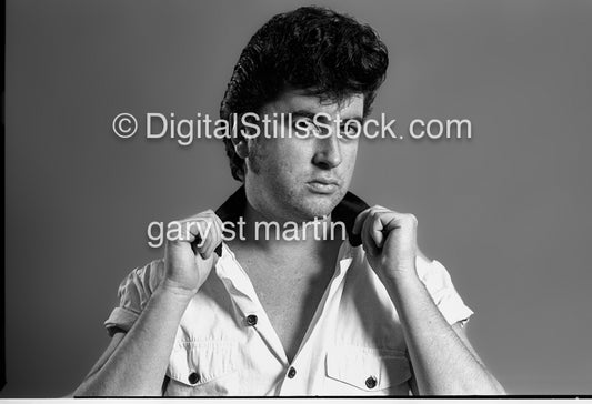 Hands on his shirt collar