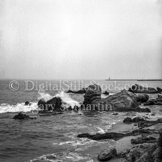 Ocean Horizon and Jagged Rocks Along Beach