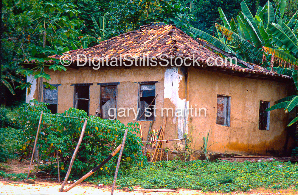 building with a thatched roof surrounded by greenery