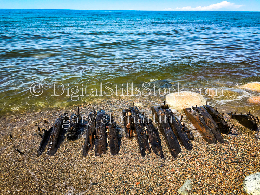Pieces of shipwreck poking out through the sand, digital Grand Marais
