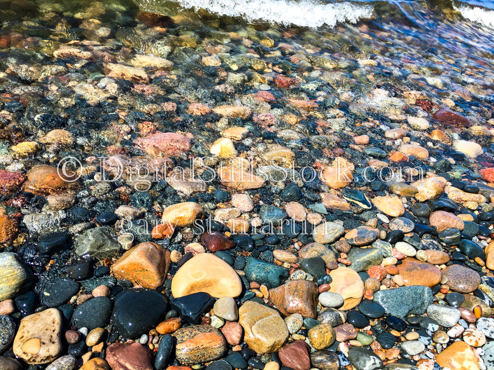 Colorful rocks getting washed up on the shore, digital Grand marais