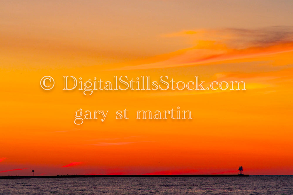 Lighthouse in the distance against an orange sky, digital Grand MArais