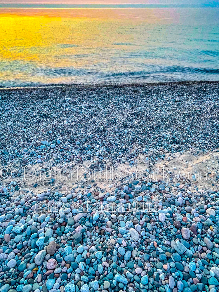 Sun set on a beach full of pebbles, digital Munising
