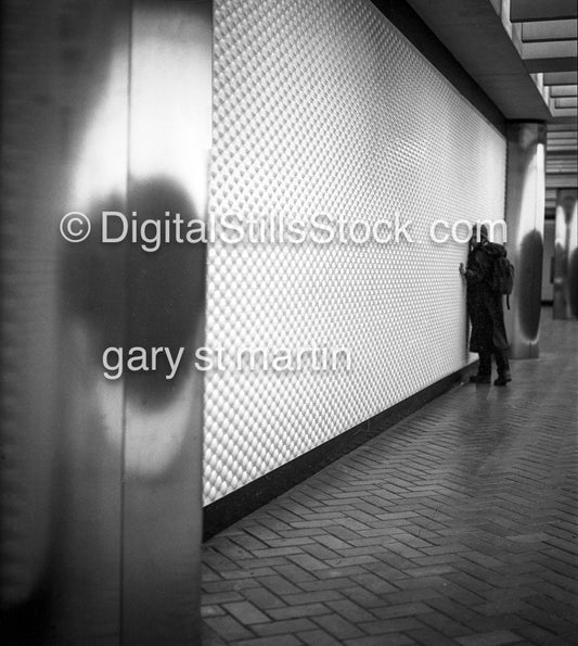 Portrait along the wall, the BART station, San Francisco, California, analog, black & white, portrait