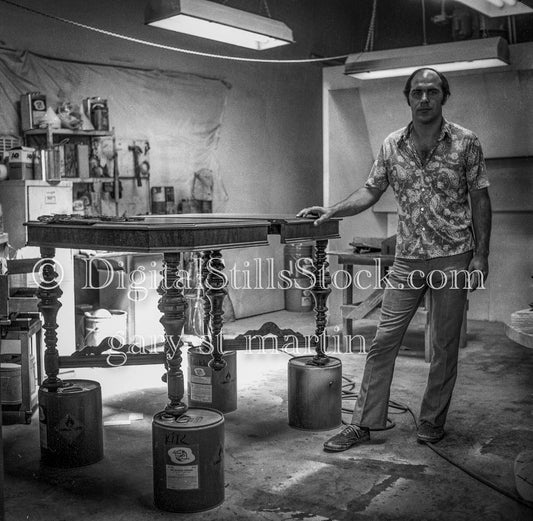 Dennis Kiklas Standing by Elevated Table Analog, Portrait, Men, Black & White