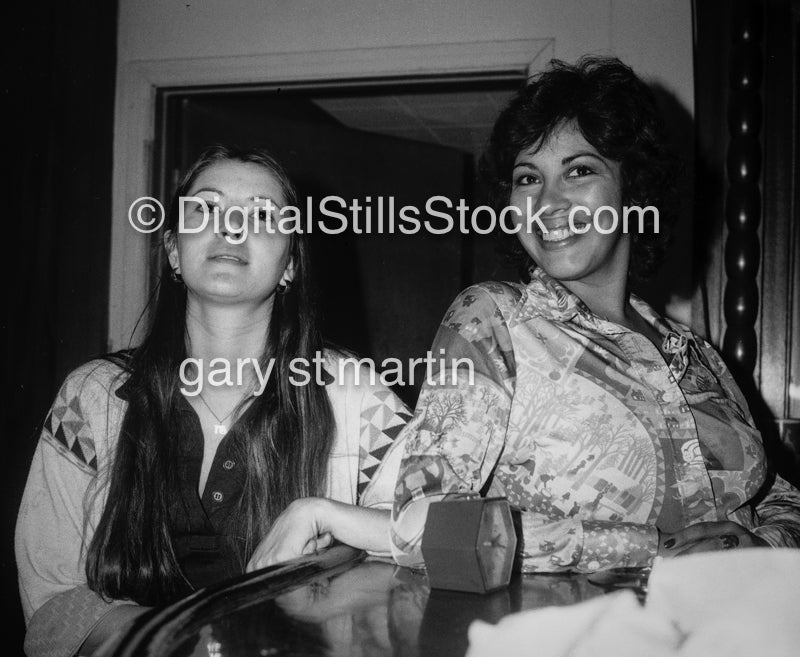 Two women posing at the table, black and white analog groups