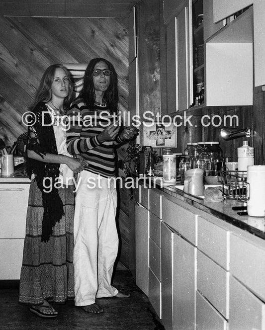 Two people standing in the Kitchen, black and white analog groups