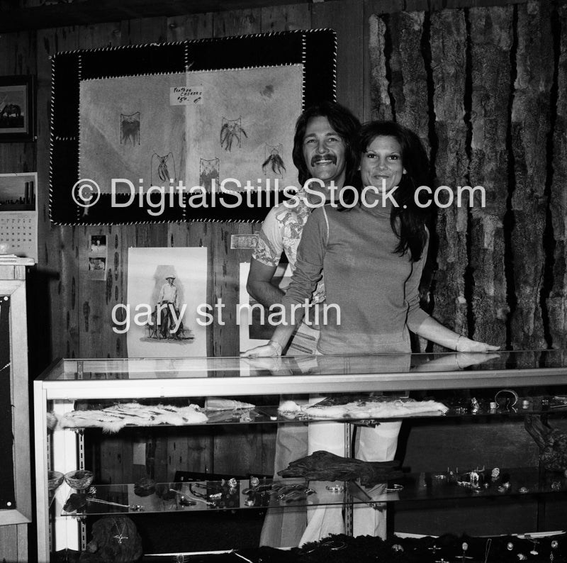 Couple posing behind the counter, black and white analog groups