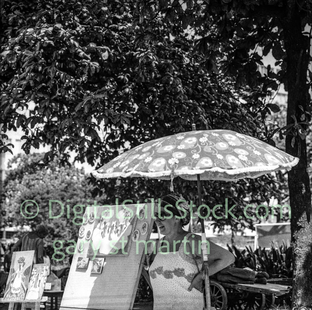 Woman with a patterned umbrella in a park setting