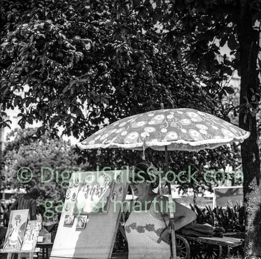 Woman with a patterned umbrella in a park setting