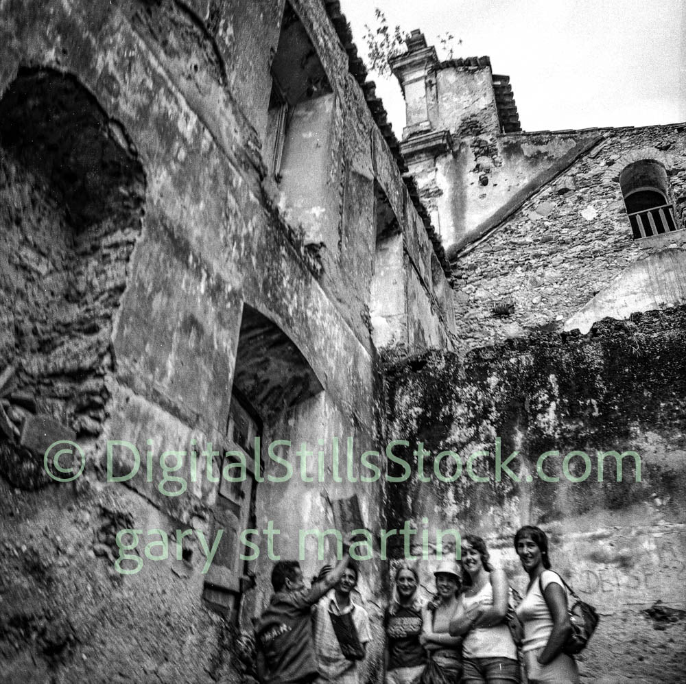 Group of people standing in the ruins of an old building