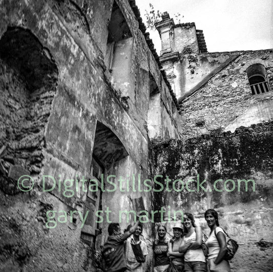 Group of people standing in the ruins of an old building