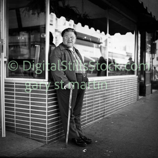 Man with Cane Leaning Along Shop Window, Analog, Polk St., B & W