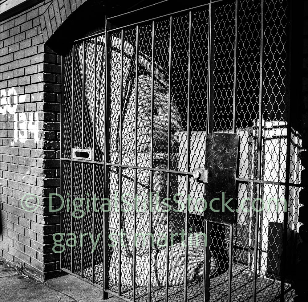 Mattress behind the gate, Downtown, San Francisco, analog, black and white, oddities