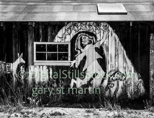 Hippie painting on a on a barn, analog, black and white, oddities