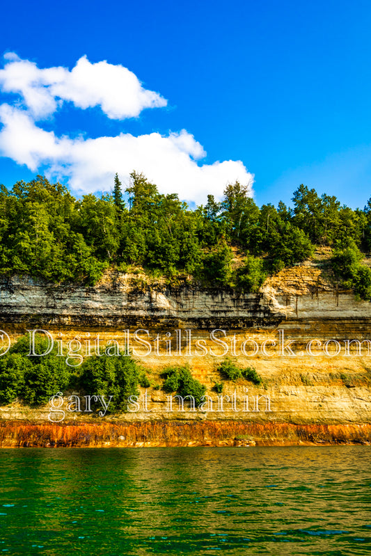 Orange rocks agains the green water, digital Munising