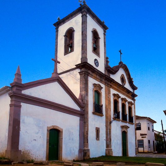 White church with a tall tower against a clear blue sky