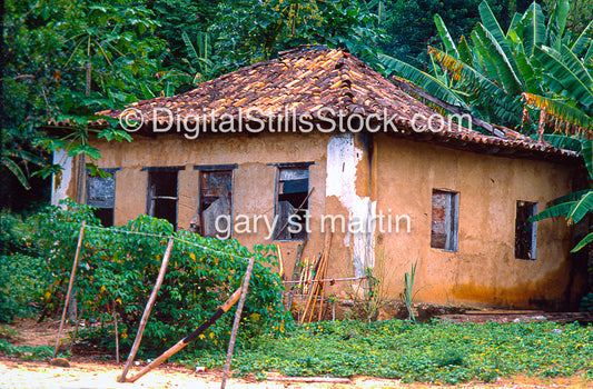 building with a thatched roof surrounded by greenery
