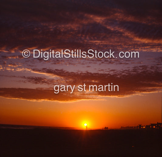 Silhouette of a person in front of the setting sun, analog sunsets