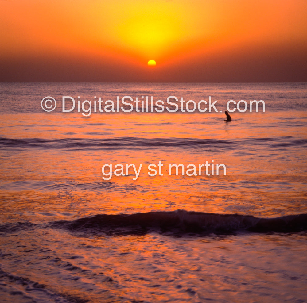 Surfer out on the water during sunset, analog sunsets