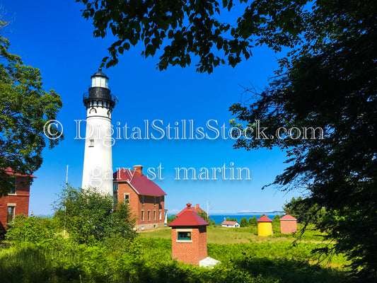 View of Sable Lighthouse and various buildings through the trees, digital Grand Marais