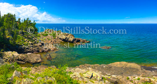 Rocky cliffs against blue green water, digital copper harbor