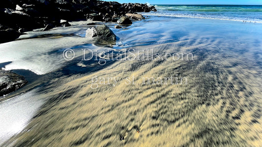 Black patterns in the wet sand, digital sunset