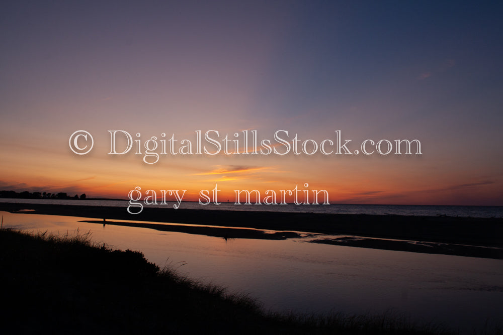 Sun rays shining as the suns sets on the water, digital Grand MArais