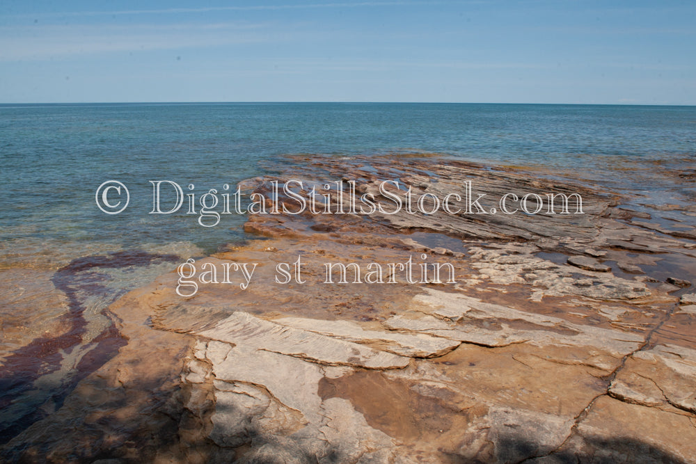 Water washing up on the layered rocks, digital Grand marais