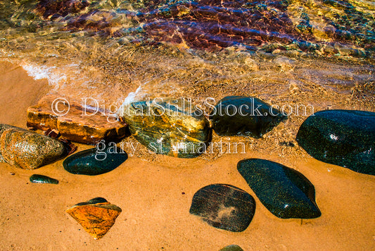Close up of water washing over large rocks, digital Grand MArais