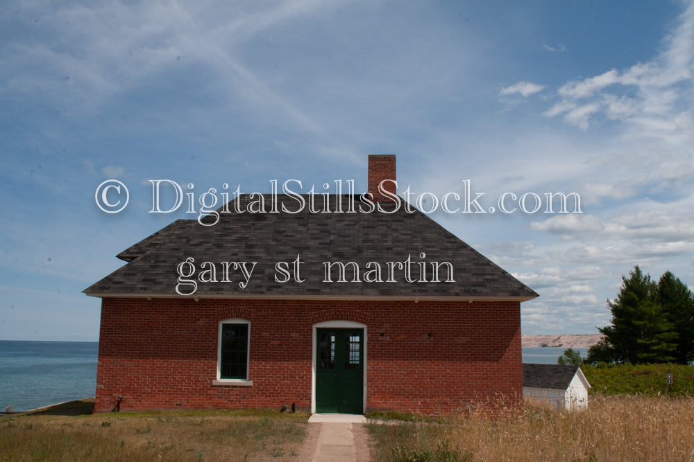 Looking at the entrance to the red brick house, digital Grand MArais