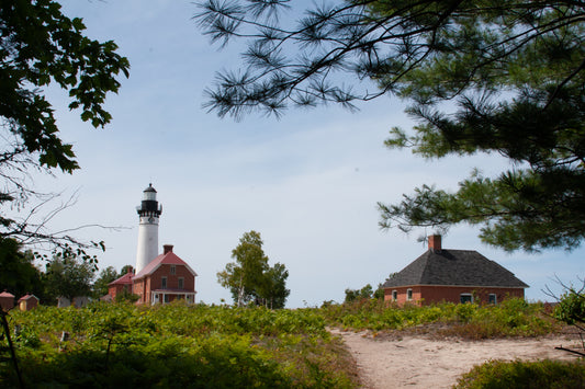 Sable Lighthouse along other brick buildings, digital Grand Marais