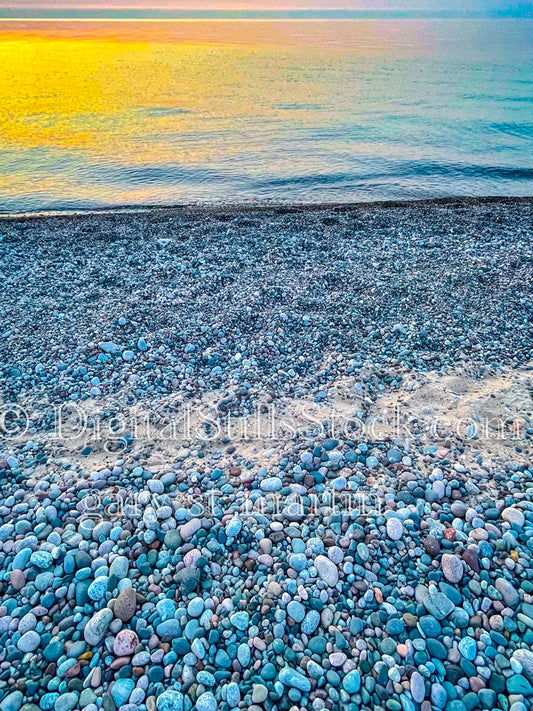 Sun set on a beach full of pebbles, digital Munising