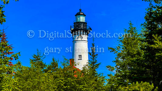 Zoomed in on the top of Sable Lighthouse peaking through the trees, digital Grand Marais