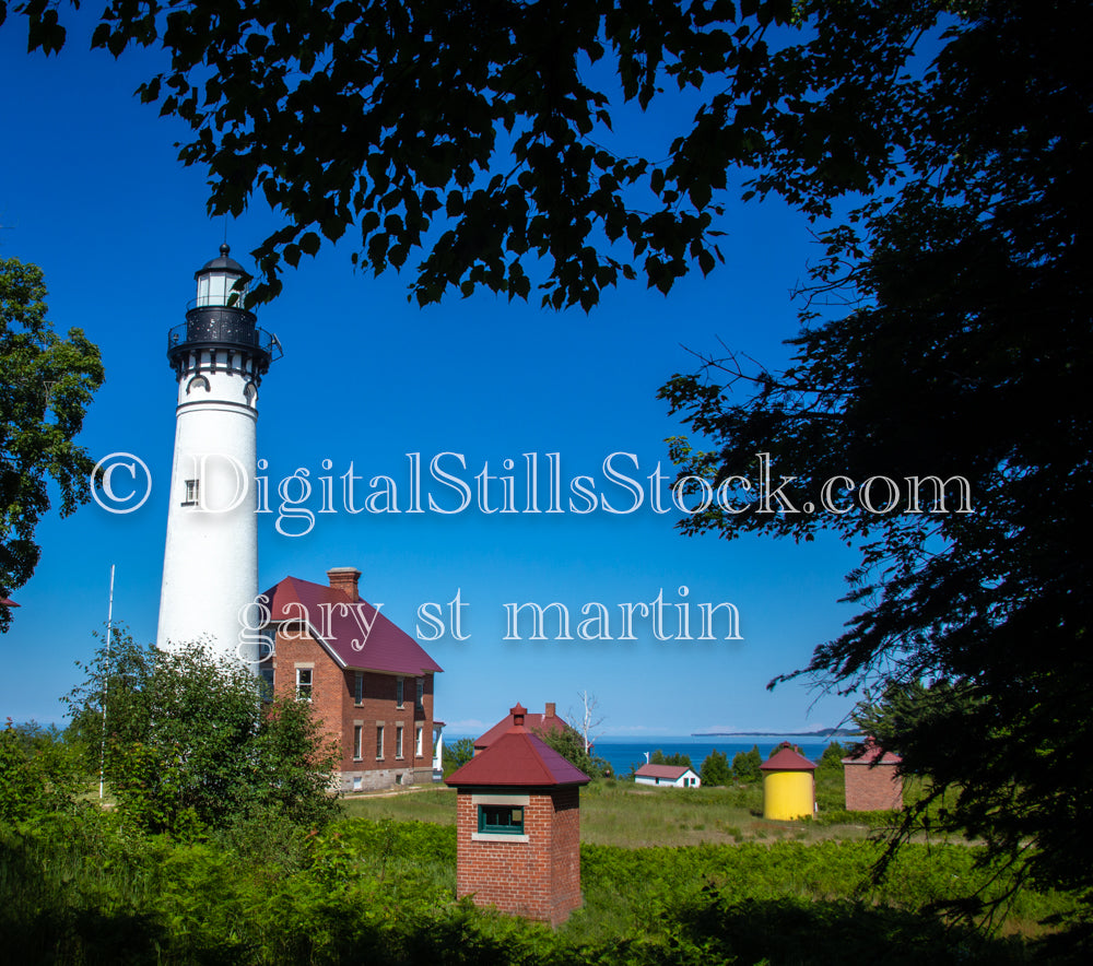 A view of Sable Lighthouse through the branches, digital grand marais