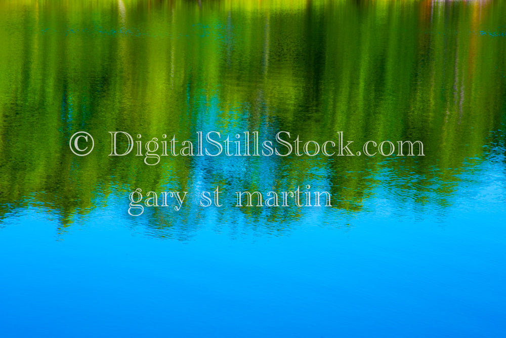 Green trees reflecting in the blue water of Sable Lake, digital grand marais