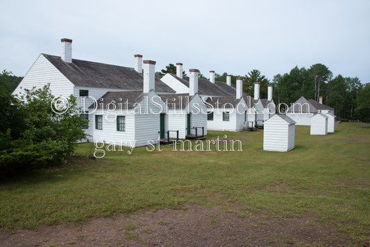 Row of white buildings with chimneys at Fort Wilkins, digital copper harbor